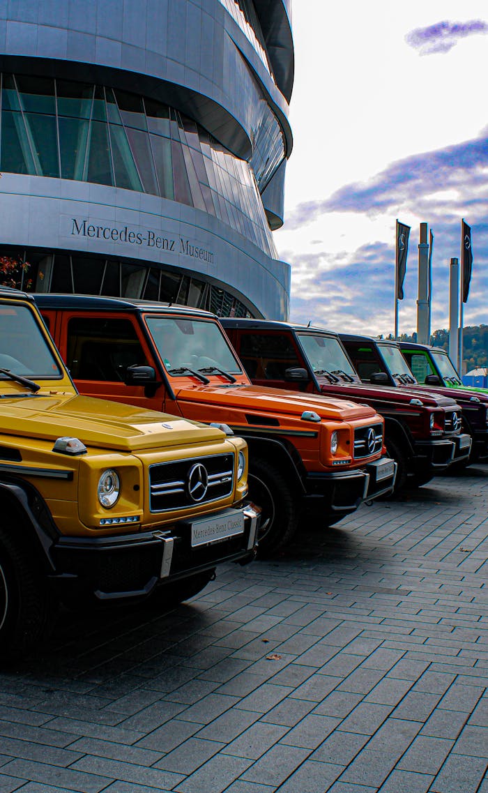 Vibrant lineup of Mercedes-Benz SUVs outside the iconic Stuttgart museum. Automotive elegance.